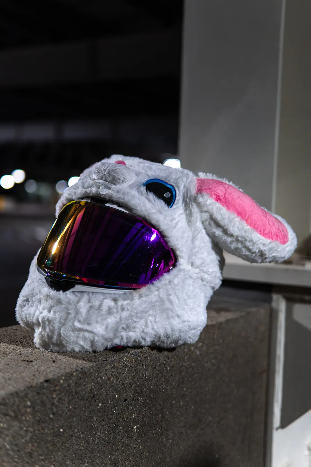 White motorcycle bunny helmet on a parking garage