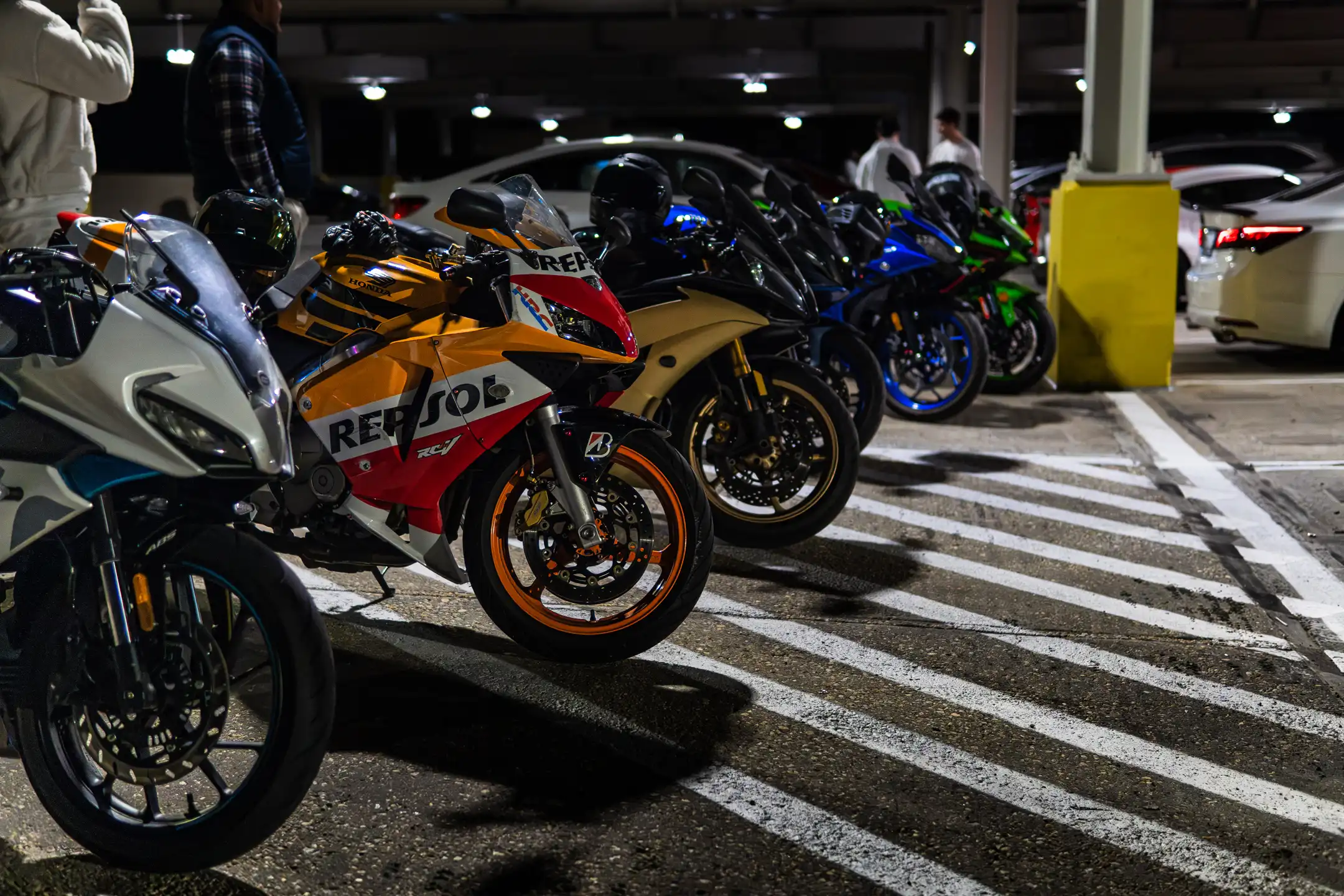 Horizontal image of Six Motorcycles Lined up in parking garage in Maryland by Antlophotography