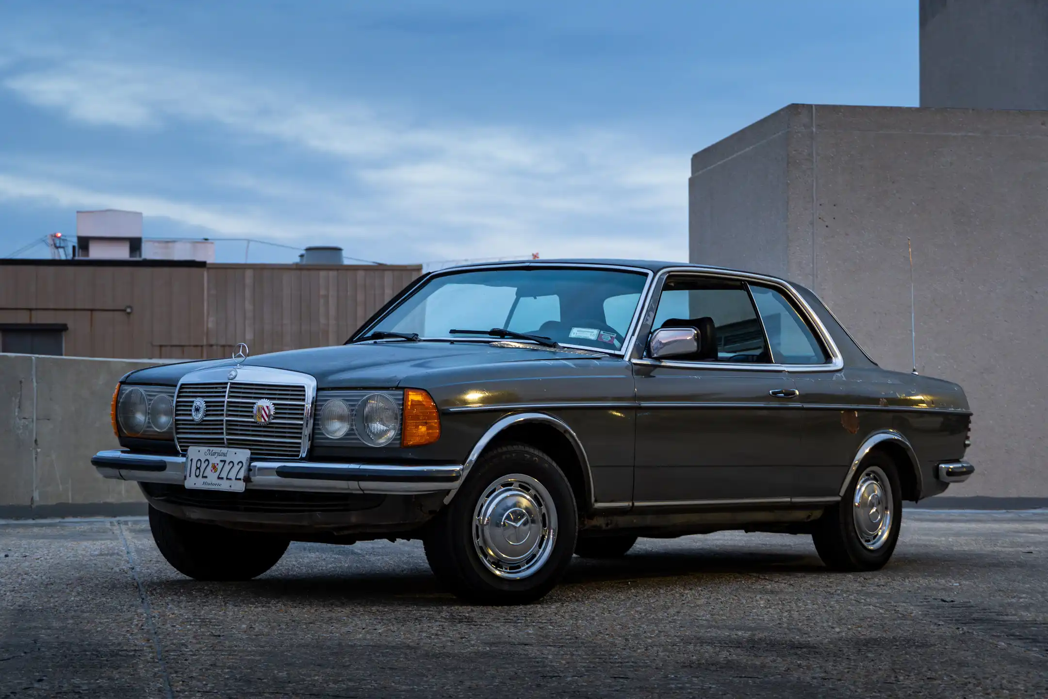 Old Mercedes car with sky background in parking lot in Maryland by Antlophotography