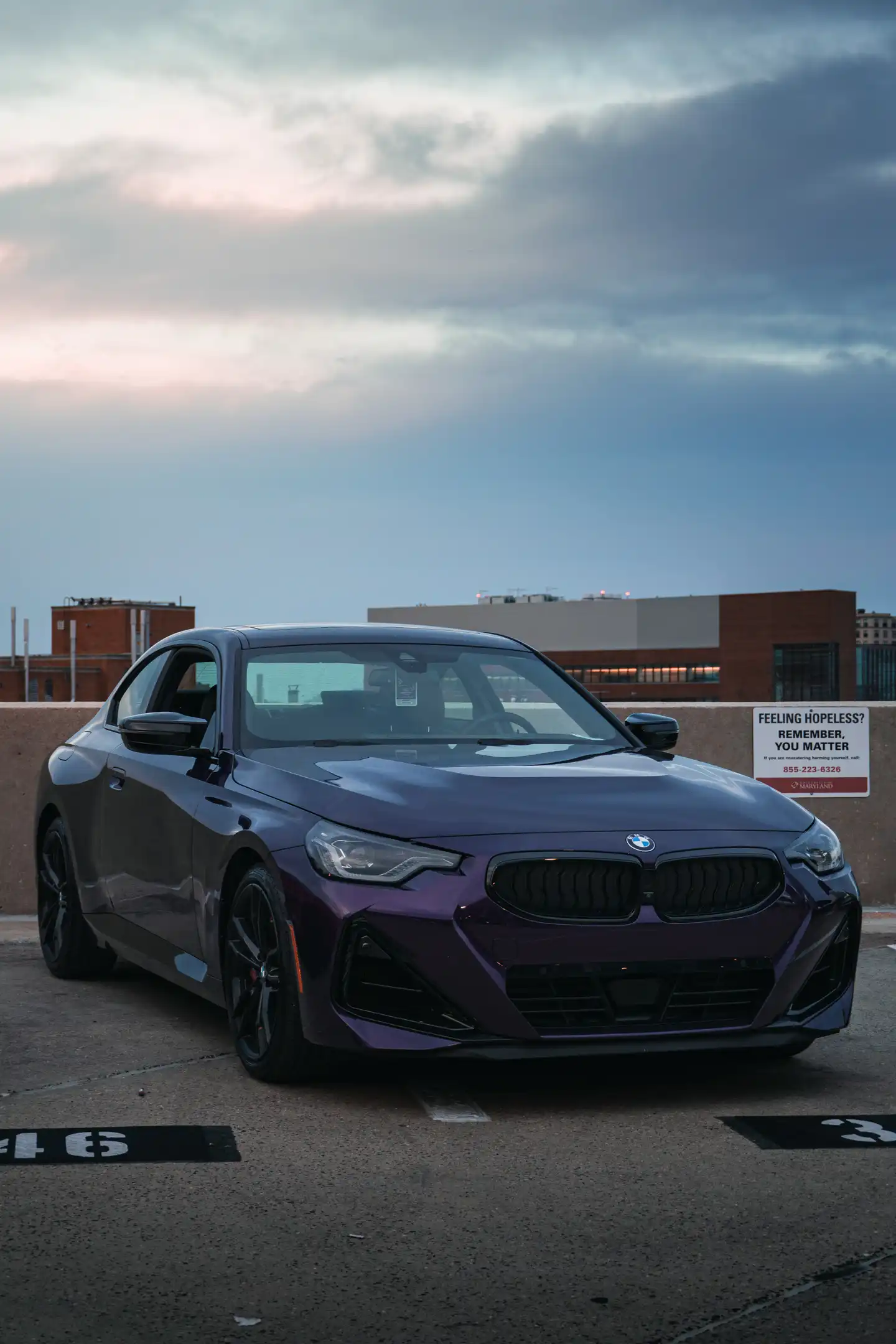 Vertical image of Purple BMW on parking garage with beautiful sky background in Maryland by Antlophotography